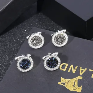 Gemelli da polso rotondi in cristallo con strass grigi e blu in una confezione