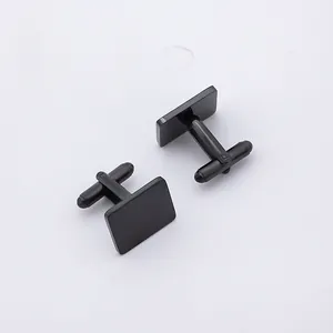 Detailed view of two polished black square cufflinks with classic T-bar swivel closures