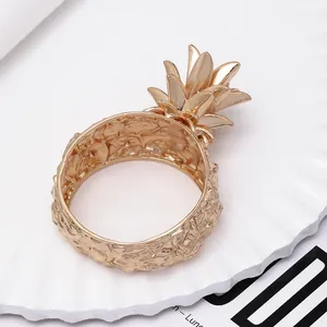 Elegant gold pineapple napkin ring with textured metal finish for hotel table decor