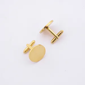 Detailed close-up of pair of polished gold round stainless steel shirt cufflinks