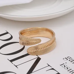 Elegant gold leaf napkin ring with intricate feather texture for luxury table settings