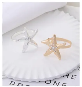 Detail of starfish napkin rings with sparkling rhinestones in gold and silver finish
