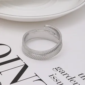 Close-up detail of leaf patterned napkin ring in silver with textured metal finish