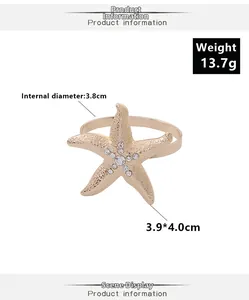 Dettaglio portatovagliolo a stella marina dorata con strass e misure indicate