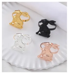 Detailed view of four rabbit napkin rings in gold, silver, black, and rose gold