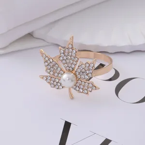 Golden maple leaf napkin ring with sparkling rhinestones and a large white pearl center