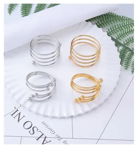 Detailed view of spiral metal napkin rings in gold and silver for elegant table settings
