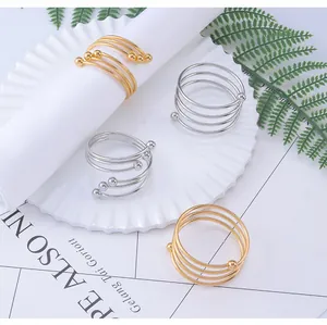 Close-up of spiral metal napkin rings with beaded ends in gold and silver finish