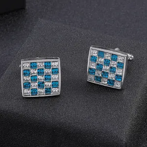 Macro shot of square cufflinks with blue and clear crystal checkerboard pattern inlay