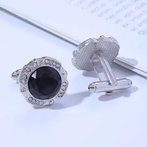 Close-up showing front and back views of silver cufflinks with black round stones