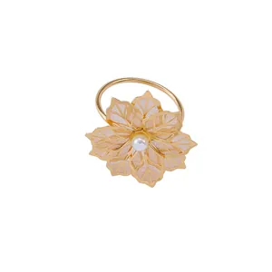 Elegant gold flower napkin ring with hollow mesh petals and a central white pearl
