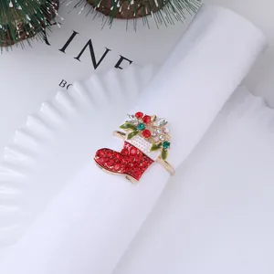 Christmas stocking napkin ring with red rhinestones and golden finish on white napkin