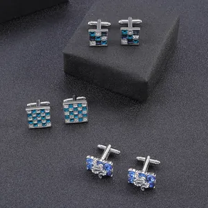 Detailed view of silver cufflinks with blue zircon grids and dragon relief patterns