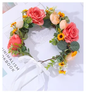 Detail of floral bridal crown with pink roses and white satin ribbon on a book