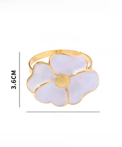 Detailed view of daisy flower napkin ring with gold finish and white enamel petals