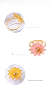 Detailed view of daisy and bee napkin rings made of premium gold alloy with floral petals