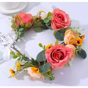 Detailed close-up of a floral bridal wreath with pink roses and white satin ribbons