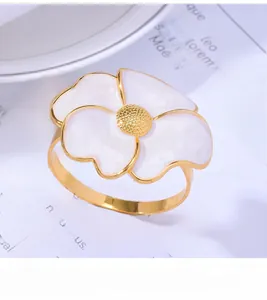 Macro shot of elegant golden daisy napkin ring with white petals and textured core