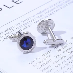 Macro view of silver round cufflinks with deep blue crystal and T-bar back clasp