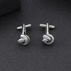 Close-up of silver-toned love knot cufflinks for men featuring polished bullet back closure