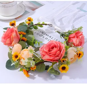 Detailed shot of handmade floral wreath with pink roses and white silk ribbons for brides