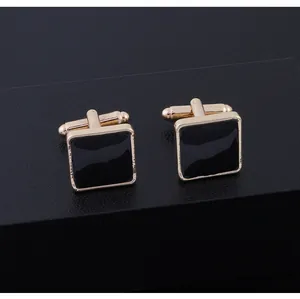 Macro view of square gold-plated cufflinks with black enamel inlay and T-bar clasp