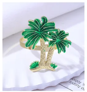Detail of tropical golden coconut tree napkin ring with green enamel leaves
