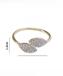 Macro detail of gold two-leaf napkin ring with measurements showing 3.4cm inner diameter