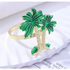 Detail of tropical palm tree napkin ring with golden stem and green enamel finish