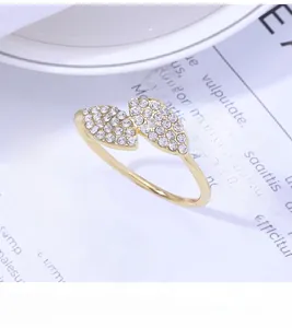 Detailed close-up of golden leaf napkin ring featuring sparkling rhinestones on elegant tableware