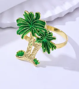 Macro detail of tropical coconut tree napkin ring with gold plating and green enamel