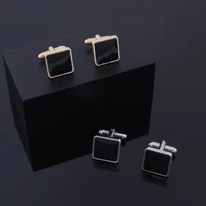 Formal square black cufflinks with polished gold and silver metal frames for men