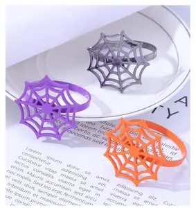 Spider web napkin ring detail in purple, orange and black for Halloween table decor
