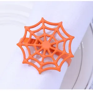 Detail of a bright orange spider web napkin ring holder for Halloween table decor