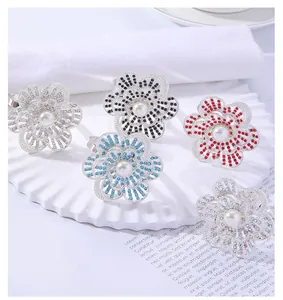 Macro detail of alloy flower napkin rings with center pearls and colorful rhinestones