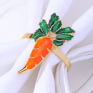 Carrot-shaped napkin ring with orange enamel finish on a gold band for table decor