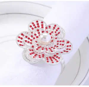 Detail showing pearl flower napkin ring with red rhinestones on white table setting