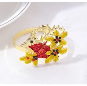 Detail of Christmas reindeer napkin ring with red rhinestones and gold floral accents