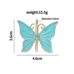 Servilletero mariposa dorada con esmalte turquesa y detalles de cristal brillante