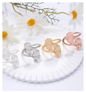 Detailed view of ginkgo leaf napkin rings in gold, silver, and rose gold finishes