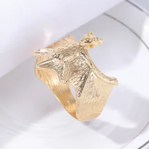 Macro shot of gold bat napkin ring with detailed texture for Halloween table decor