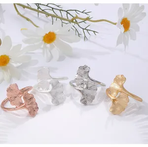 A detailed view of ginkgo leaf napkin rings in four elegant metallic finishes for table