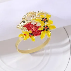 Golden Christmas reindeer napkin ring with red rhinestones and festive floral accents