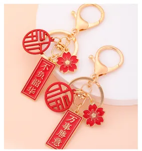 Detailed macro view of Chinese blessing keychains with red enamel charms and gold plating