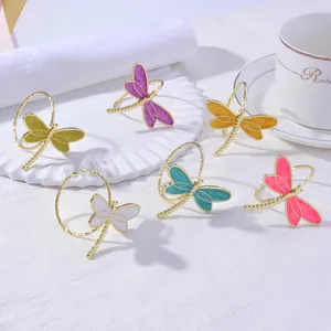 Set of 6 golden dragonfly napkin rings with colorful enamel wings for elegant dining