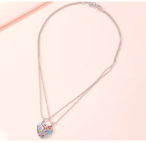 Close-up of heart-shaped BFF necklaces with colorful rhinestones and Best Friends engraving