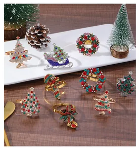 Detail of colorful rhinestone Christmas tree and wreath napkin rings on a wooden table