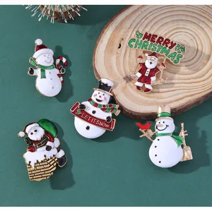 Detailed view of 5-piece enamel Christmas brooch set with Santa and snowman designs