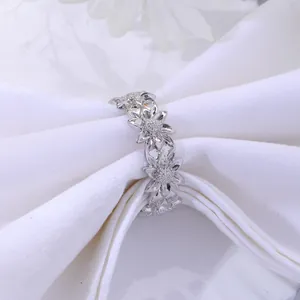 Detailed view of silver sunflower napkin ring with sparkling crystals for elegant dining