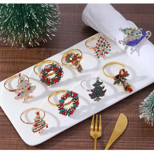 Detail view of multicolored rhinestone Christmas tree and wreath napkin rings on a plate